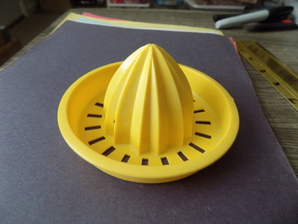 Yellow hard  plastic lemon juice squeezer 4 inch round