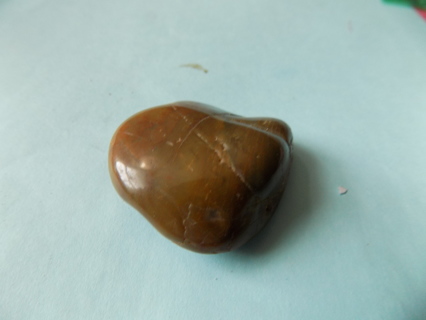 Polished brown gemstone 2 inch wide has wording on back says HONESTY