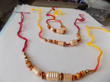 Set of 3 yellow and red thread bracelets with pearl covered cylinder beads wood beads, gold beads