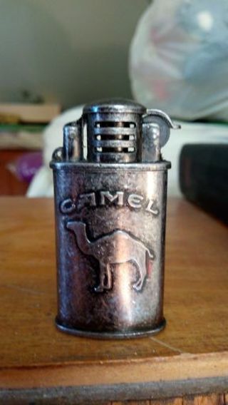 CAMEL LIGHTER.. NEW OLD STOCK. NEVER USED. IN ORIGINAL BOX WITH PAPERWORK.. JUST NEEDS FLUID