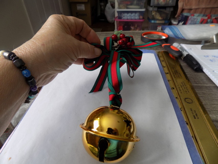 Large goldtone jingle bell on red and green ribbon door knob decoration holly on top