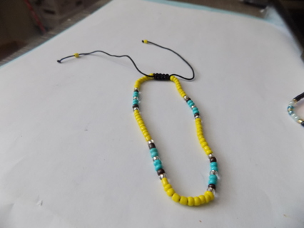 Bracelet E beads yellow, aqua, black, gold