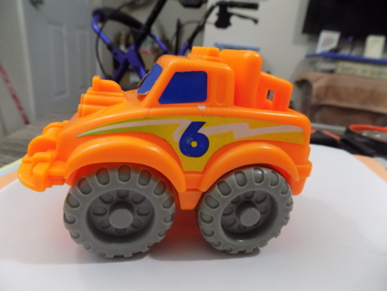 Orange plastic truck has # 6 on the door