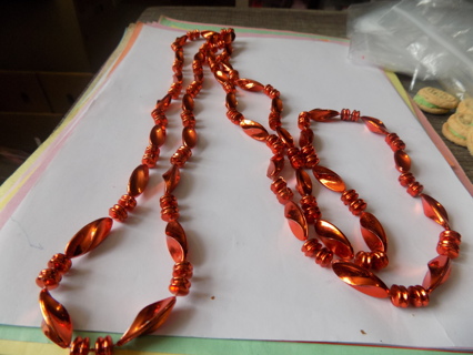 Xtra long twisted copper color bead necklace with pairs of 2 round separators between them