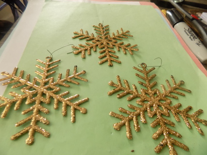 Set of 3 gold sparkly plastic flat snowflake ornaments