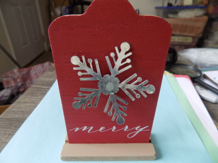 6 inch tall wood decoration with metal snowflakes and says Merry