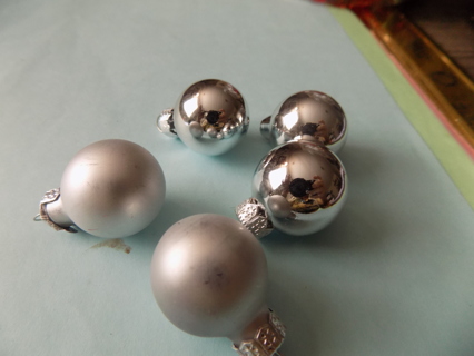 5 round silver ornaments 3 are shiny 2 satin finish