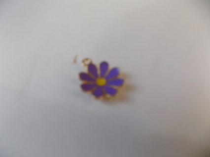 Purple enameled daisy shape charm with curled up petals