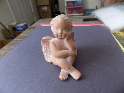 3 inch terra cotta stoneware angel/ cherub sits up legs crossed hand on her cheek