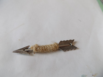 2 1/2 inch long silvertone arrow charm wrapped in jute string