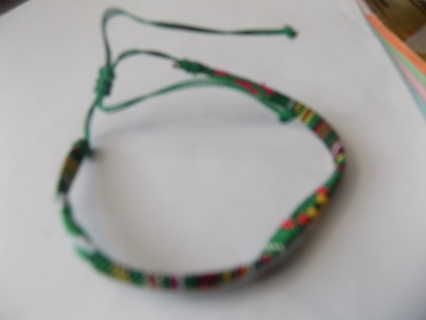 Bracelet woven thread mostly green and other colors