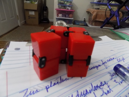 Red cube forever folding fidget toy Shawshank Leeta folds up, down, sideways