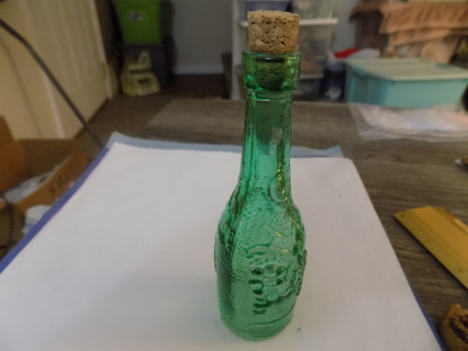 5inch tall green glass corked bottle has 3D grapes bunches on it