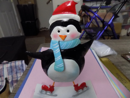 Hand painted metal penguin in Santa hat and scarf on ice skates and rocker base 8 inch