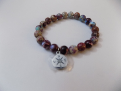 Bracelet carved round multi color brown Malekite beads, & compass point charm