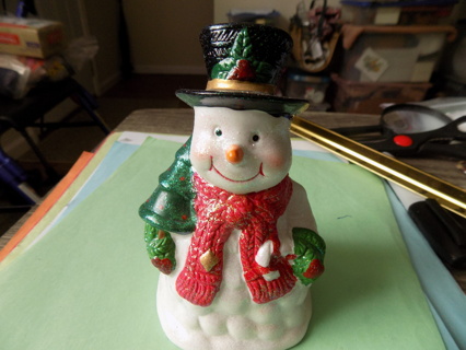 4 inch tall glittery ceramic snowman holds a tree wears red scarf, top hat,trim in holly