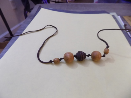 Hand made necklace of wooden beads on rawhide string