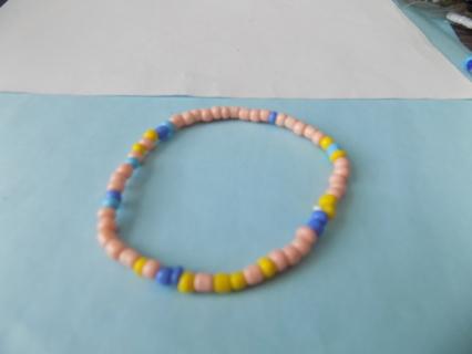 Bracelet multi color E beads mostly pink, few blue, yellow