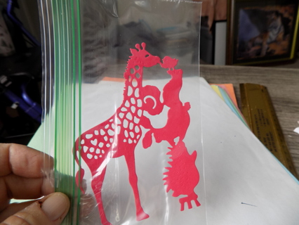 red diecut animals standing on each others shoulder to kiss a giraffe