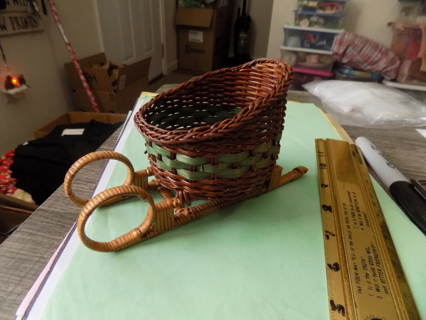 7 inch long woven sleigh with wood and rattan wrapped runners