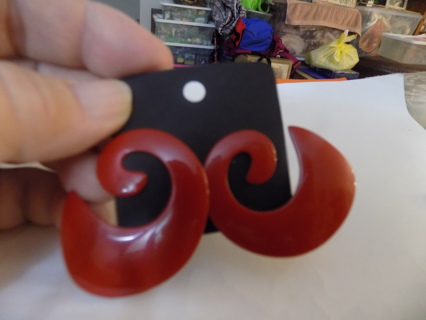 Large red metal swirl post earrings