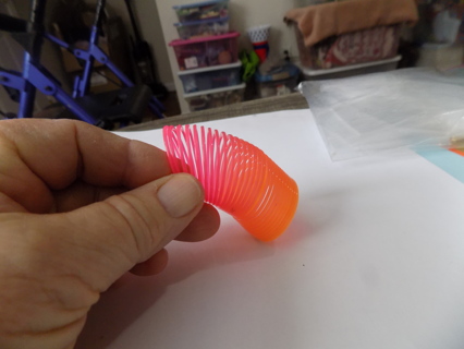 pink, and orange mini plastic slinky toy