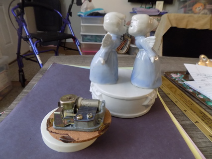 Vintage pair of porcelain kissing angels in blue gowns and  a music box mechanism