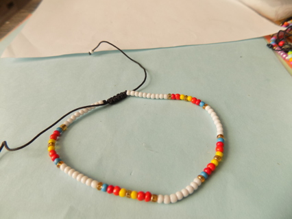 Bracelet E beads, white, red, yellow light blue, gold