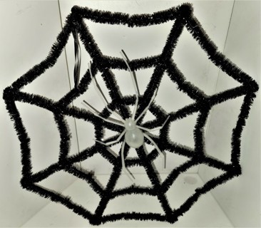 Decorative black Halloween web with large white plastic spider - size of web 16" x 16"