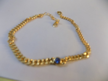 Goldtone chain bracelet with 1 small round sky blue gemstone