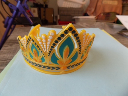 Yellow plastic princess crown trimmed in blue