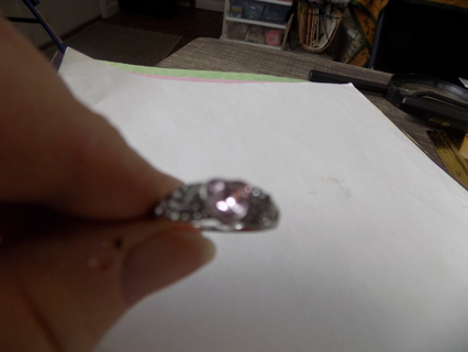 Silvertone wide band ring size 10 with light pink stone & lots of clear ones