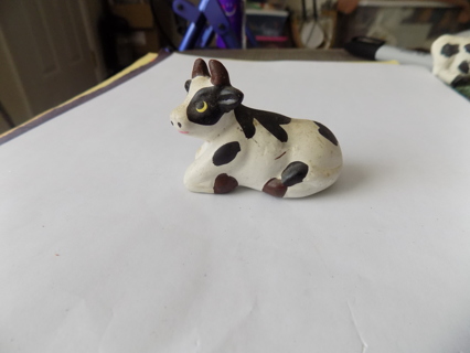 2 1/2 inch long black and white cow lying down