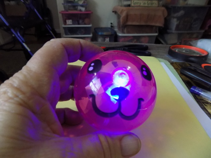 3  inch round light up color changing pink ball with puppy face painted on it