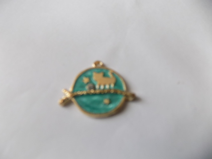 blue enamel cat charm walking across a branch 1 inch round