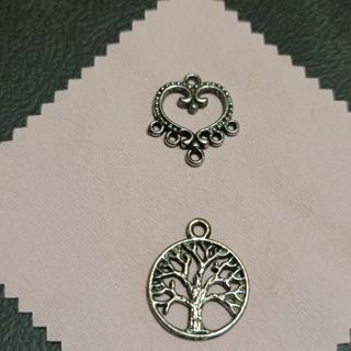 2 silver pendants, tree of life and filigree heart.