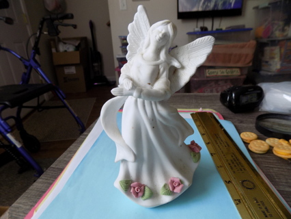 8 inch tall white bisque porcelain angel with pink roses around bottom of gown and holds rose