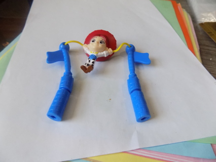 Disney's Toy Story Jessie the cowgirl twirls on rope between 2 poles