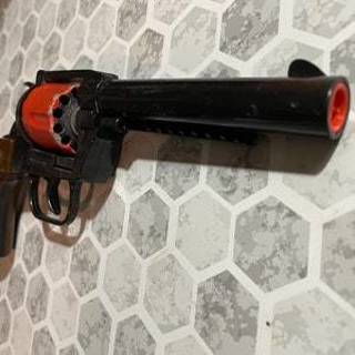 EN Toy Cap Gun with a Black Barrel Brown Grips and a Red Bandolier