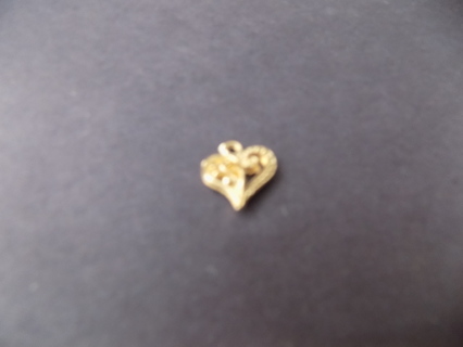 goldtone tilted heart charm with filigree on 1 side, metal dots on other & swirls