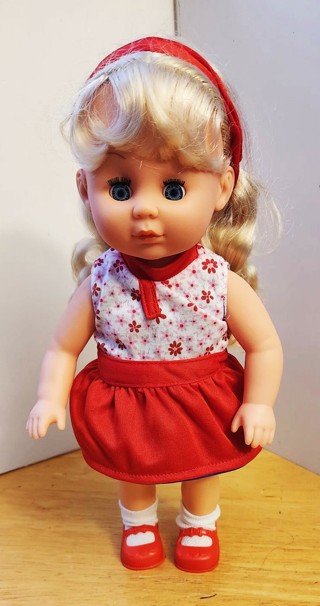 Plastic blonde doll 12" tall eyes open & close arms & legs can move weight 10 oz.  made in China