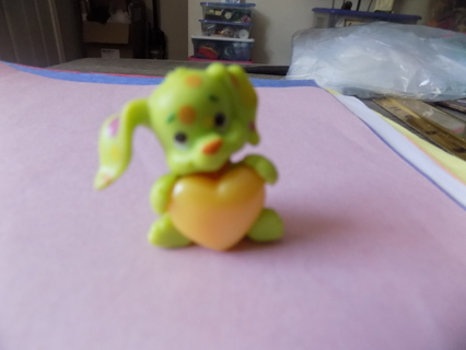 2 inch tall lime green acrylic bunny with pink polkadots holds yellow heart