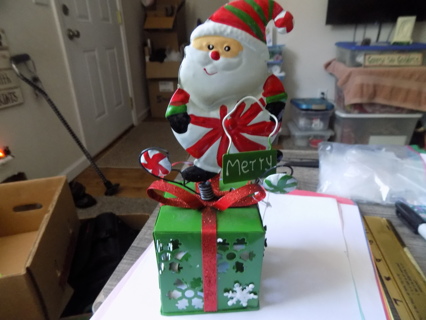 10 inch all metal green cut out present with Santa on a spring on top