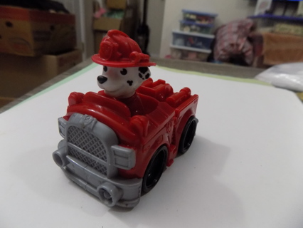 Paw Patrol Marshall in firetruck and fire fighters helmet