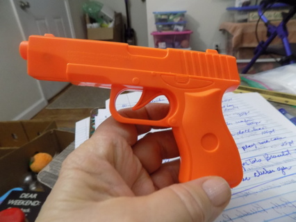 5 inch orange plaster clicker toy gun