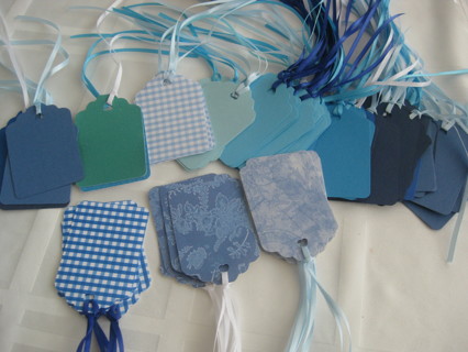 Lot of 13 gift tags with ribbons attached, different shades/designs of blue      