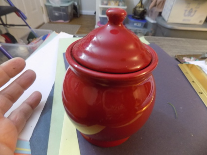 Small red ceramic ginger jar candle holder Strong scented candle still in it