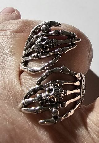 Skeletal Fingers with Skulls Ring