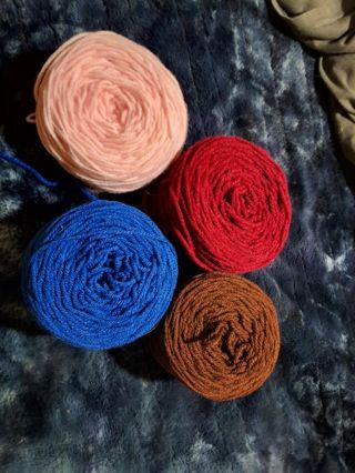 4 different color skeins of yarn, adding a light purple skein