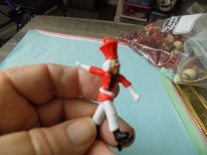 2 1/2 inch plastic toy soldier ornament ice skating dressing in red & white suit